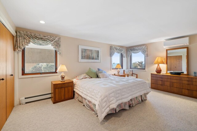 bedroom featuring recessed lighting, a closet, baseboard heating, light carpet, and a wall mounted air conditioner