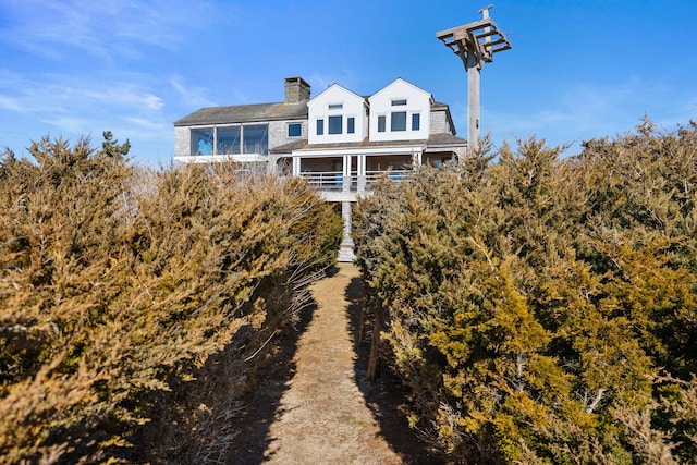 back of property with a chimney