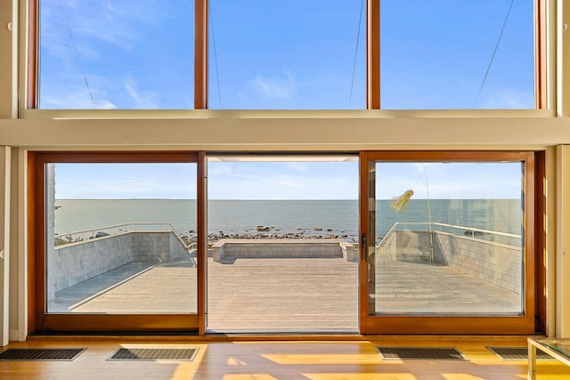 doorway featuring a water view and visible vents