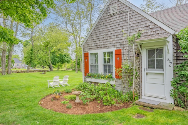 350 Plum St, West Barnstable, MA 02668 - view of property exterior featuring a lawn and roof with shingles