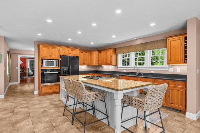 350 Plum St, West Barnstable, MA 02668 - kitchen featuring black appliances, a kitchen island, a sink, a kitchen bar, and recessed lighting