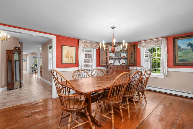 350 Plum St, West Barnstable, MA 02668 - dining space with a chandelier, a baseboard radiator, and light tile patterned floors