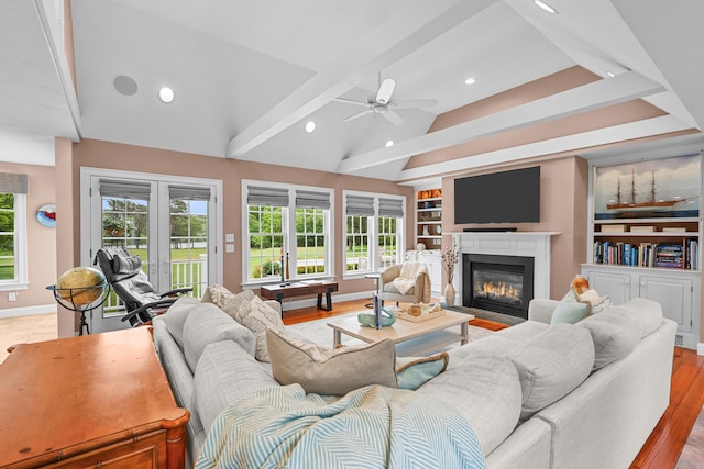 350 Plum St, West Barnstable, MA 02668 - living room featuring a fireplace with flush hearth, healthy amount of natural light, built in shelves, recessed lighting, and a ceiling fan