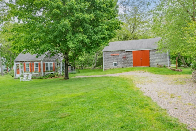350 Plum St, West Barnstable, MA 02668 - view of grassy yard with an outdoor structure, gravel driveway, and a barn