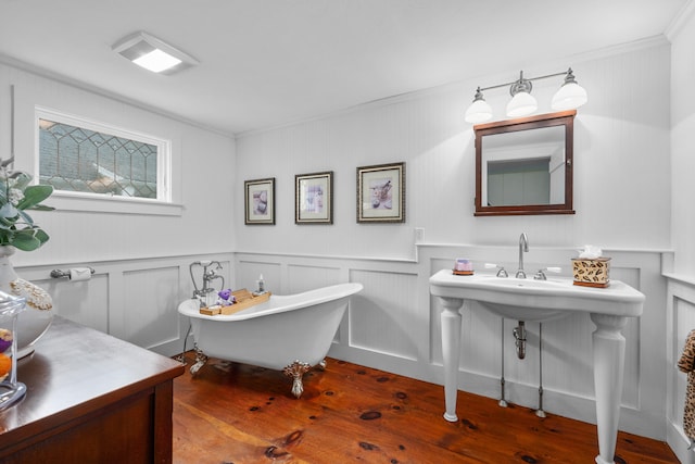 350 Plum St, West Barnstable, MA 02668 - bathroom with wood finished floors, a freestanding tub, a decorative wall, ornamental molding, and a wainscoted wall