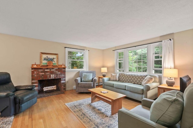 566 County Rd, Pocasset, MA 02559 - living area with light wood-style flooring, a fireplace, and a baseboard heating unit