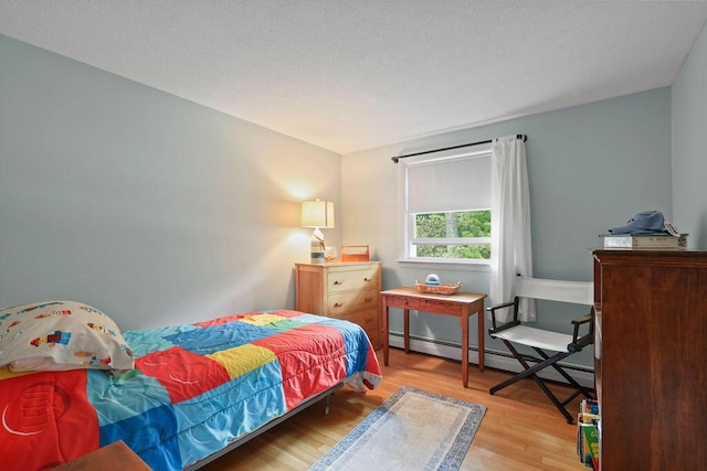 566 County Rd, Pocasset, MA 02559 - bedroom with a baseboard radiator and light wood finished floors