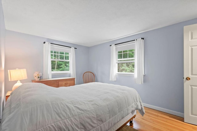 566 County Rd, Pocasset, MA 02559 - bedroom with wood finished floors and multiple windows