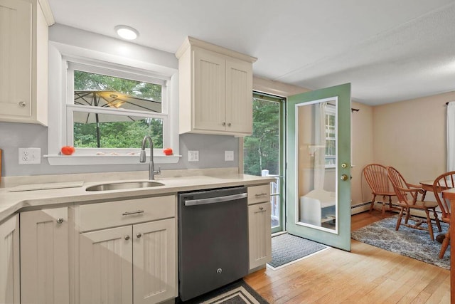 566 County Rd, Pocasset, MA 02559 - kitchen with stainless steel dishwasher, light wood-style floors, and light countertops