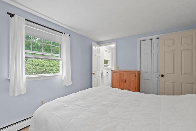 566 County Rd, Pocasset, MA 02559 - bedroom featuring baseboard heating and a closet