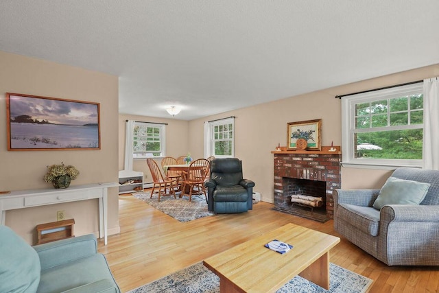 566 County Rd, Pocasset, MA 02559 - living room with light wood-style flooring and a fireplace