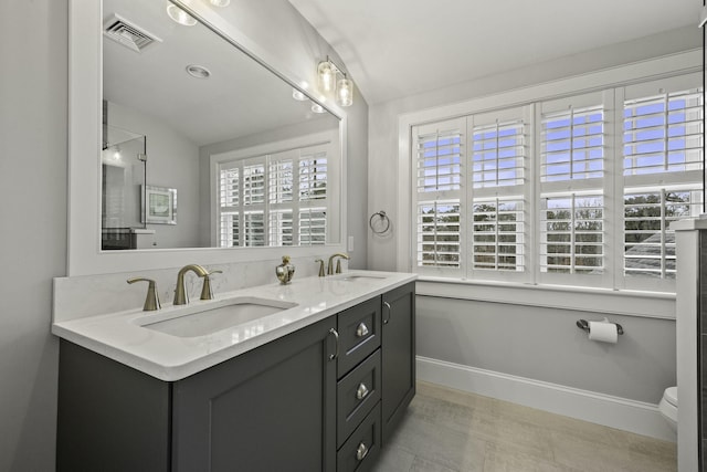 5 Jakes Ln, Brewster, MA 02631 - bathroom with visible vents, a sink, baseboards, and double vanity
