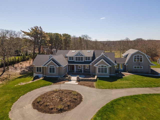 5 Jakes Ln, Brewster, MA 02631 - view of front of home with curved driveway, a porch, and a front lawn