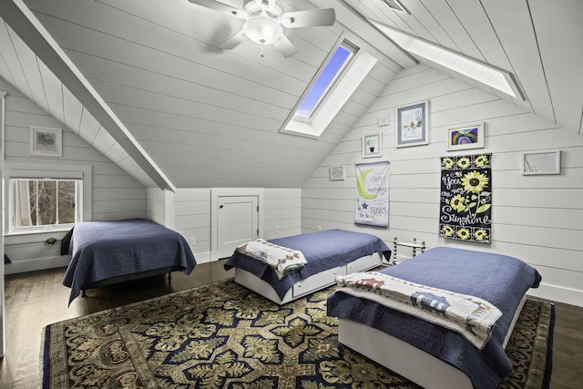 5 Jakes Ln, Brewster, MA 02631 - bedroom with wooden walls, a ceiling fan, wood finished floors, and lofted ceiling with skylight