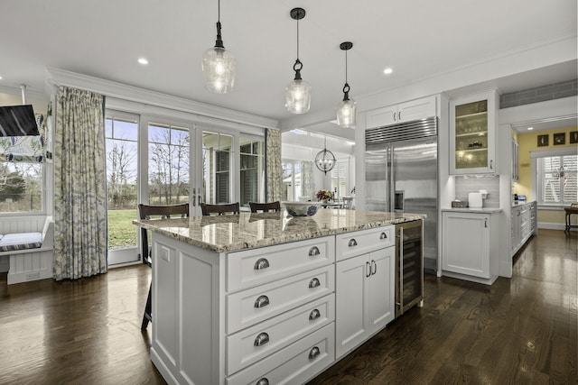 5 Jakes Ln, Brewster, MA 02631 - kitchen with stainless steel built in fridge, dark wood finished floors, wine cooler, white cabinets, and glass insert cabinets