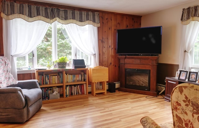 103 Moco Rd, West Barnstable, MA 02668 - living area featuring light wood-style floors, a glass covered fireplace, and wood walls