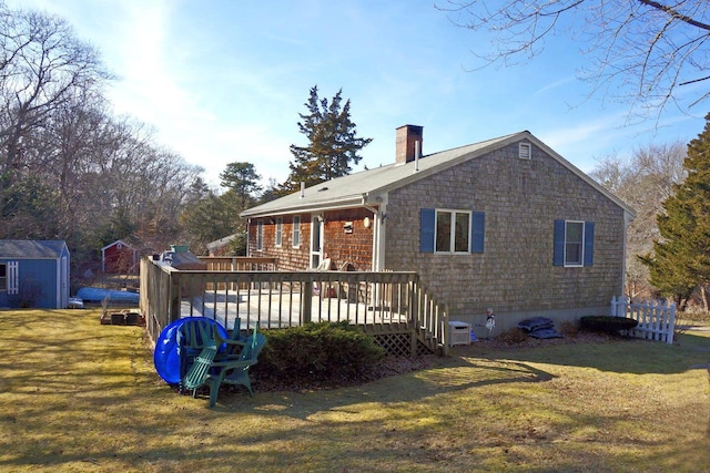 103 Moco Rd, West Barnstable, MA 02668 - rear view of property with a chimney, a lawn, a wooden deck, and a shed