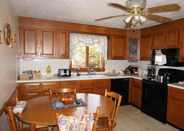103 Moco Rd, West Barnstable, MA 02668 - kitchen featuring black appliances, brown cabinetry, and light countertops