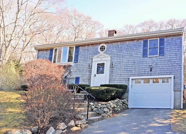 103 Moco Rd, West Barnstable, MA 02668 - raised ranch featuring a chimney, a garage, and driveway