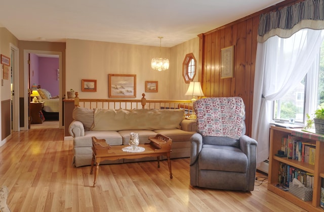 103 Moco Rd, West Barnstable, MA 02668 - living area featuring a chandelier, light wood-type flooring, plenty of natural light, and wooden walls