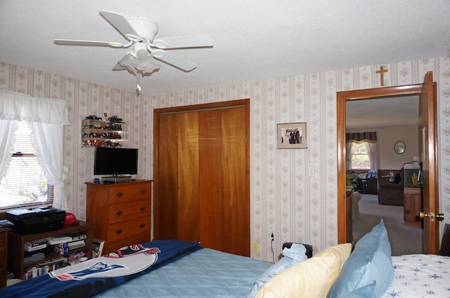 103 Moco Rd, West Barnstable, MA 02668 - bedroom with a closet, wallpapered walls, and a ceiling fan
