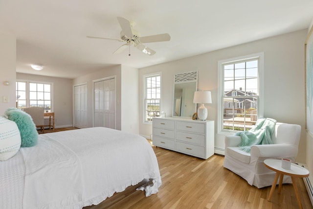 14 Kendrick Ave, Wellfleet, MA 02667 - bedroom with multiple closets, light wood-style floors, baseboard heating, ceiling fan, and baseboards