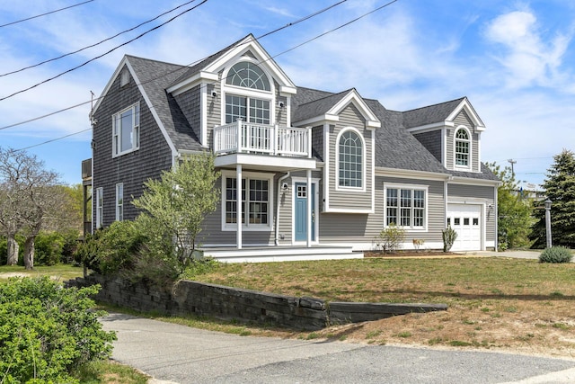 14 Kendrick Ave, Wellfleet, MA 02667 - view of front of home with a balcony, a garage, a shingled roof, and a front lawn