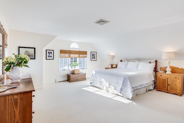 bedroom with lofted ceiling, light colored carpet, and baseboard heating