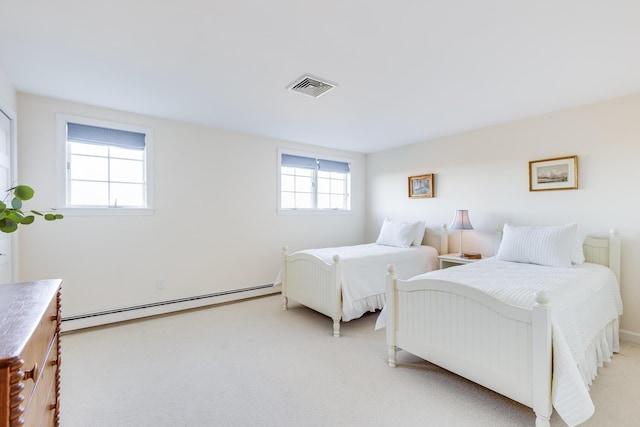 carpeted bedroom with a baseboard heating unit