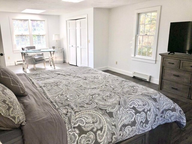 341 Service Rd, Sandwich, MA 02563 - bedroom with baseboards, baseboard heating, a closet, and wood finished floors