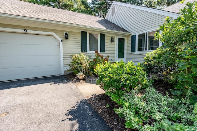9 Pacific Ave, Mashpee, MA 02649 - view of front of home with roof with shingles, a garage, and driveway