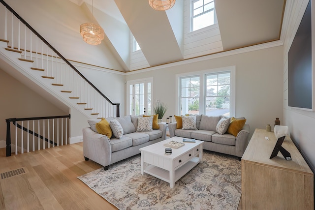 72 Woodside Dr, East Falmouth, MA 02536 - living room featuring light wood-style floors, high vaulted ceiling, visible vents, and stairway