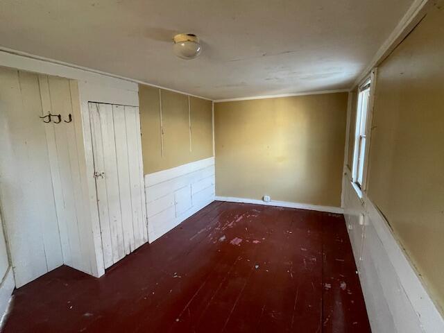 unfurnished bedroom with dark wood-type flooring