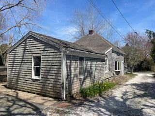 view of property exterior with a chimney