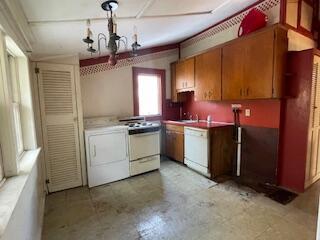 kitchen featuring washer / clothes dryer, a chandelier, and white appliances