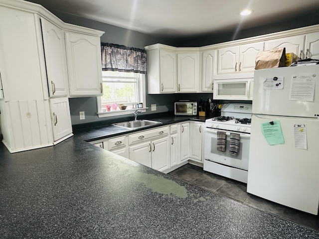 96 Machester Ave, Oak Bluffs, MA 02557 - kitchen featuring white appliances, a sink, dark countertops, white cabinets, and recessed lighting