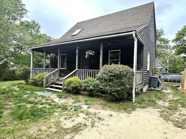 96 Machester Ave, Oak Bluffs, MA 02557 - view of front facade featuring roof with shingles and covered porch