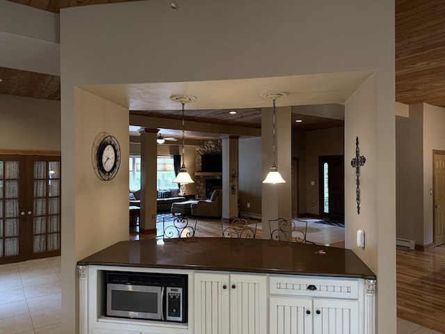 3 Wolf Rd, Buzzards Bay, MA 02532 - kitchen featuring dark countertops, stainless steel microwave, a baseboard radiator, wood ceiling, and ceiling fan