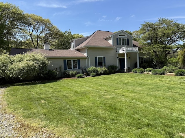 3 Wolf Rd, Buzzards Bay, MA 02532 - traditional-style house with a front lawn, a balcony, and a shingled roof