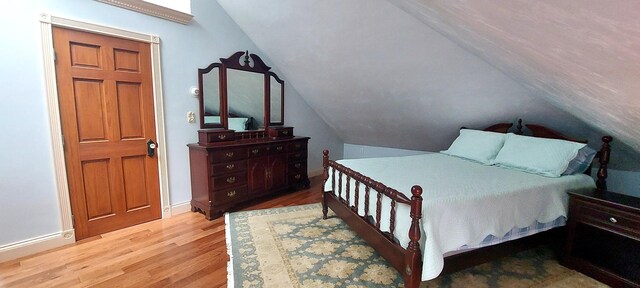 3 Wolf Rd, Buzzards Bay, MA 02532 - bedroom with wood finished floors, vaulted ceiling, and baseboards