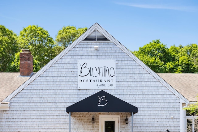 213 N Falmouth Hwy Unit 5B, North Falmouth, MA 02556 - exterior space with gutters, roof with shingles, a chimney, and a downspout
