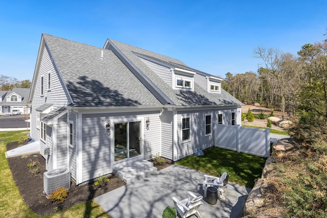 213 N Falmouth Hwy Unit 5B, North Falmouth, MA 02556 - back of property featuring a yard, a patio, central air condition unit, a shingled roof, and entry steps
