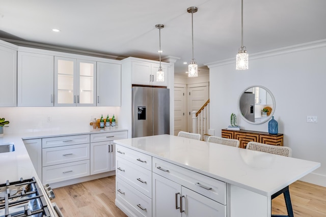 213 N Falmouth Hwy Unit 5B, North Falmouth, MA 02556 - kitchen featuring stainless steel fridge with ice dispenser, a kitchen bar, light wood finished floors, white cabinets, and recessed lighting