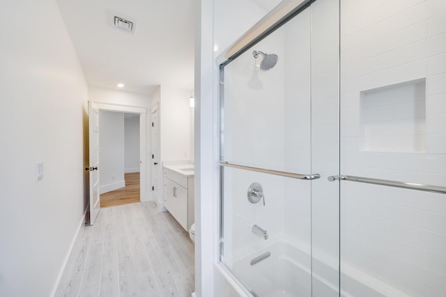 213 N Falmouth Hwy Unit 5B, North Falmouth, MA 02556 - full bath with baseboards, visible vents, vanity, wood finished floors, and combined bath / shower with glass door