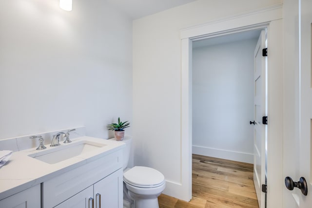 213 N Falmouth Hwy Unit 5B, North Falmouth, MA 02556 - half bathroom with toilet, vanity, wood finished floors, and baseboards