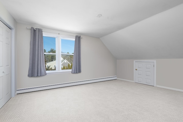 additional living space with baseboard heating, carpet flooring, baseboards, and vaulted ceiling