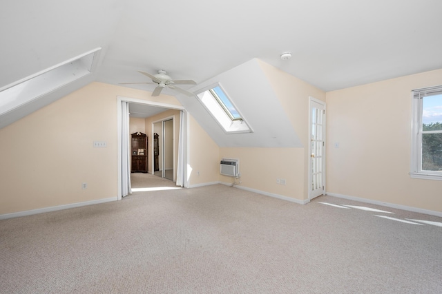 additional living space with baseboards, carpet flooring, a wall mounted air conditioner, and ceiling fan