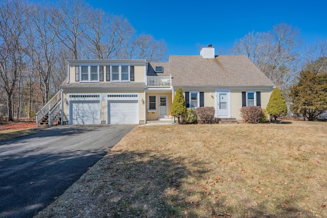 view of front of house featuring a chimney, driveway, a shingled roof, and a garage