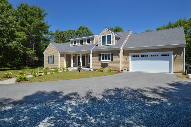 26 Crosswinds Way E, Falmouth, MA 02536 - view of front facade featuring driveway, a garage, covered porch, roof with shingles, and a front yard