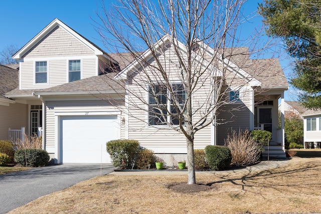 view of front of home with a garage, aphalt driveway, and a shingled roof